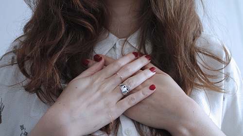 person woman wearing silver-colored ring hands