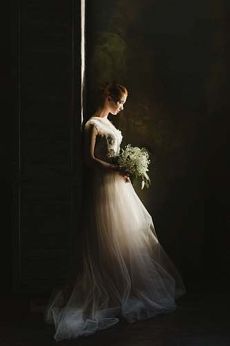 wedding woman wearing wedding gown white holding bouquet portrait