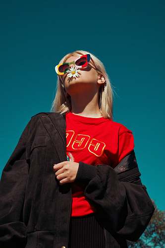person woman with sunglasses standing outdoor during daytime human