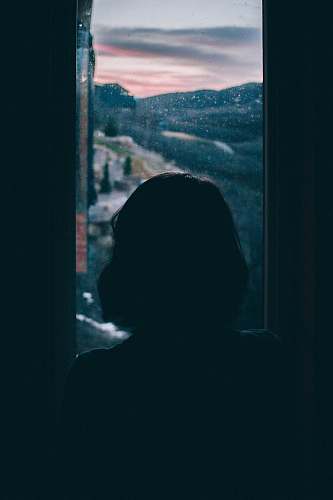 person women's silhouette facing outside window human