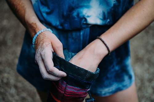 people close-up photography of person holding black and pink pouch hand