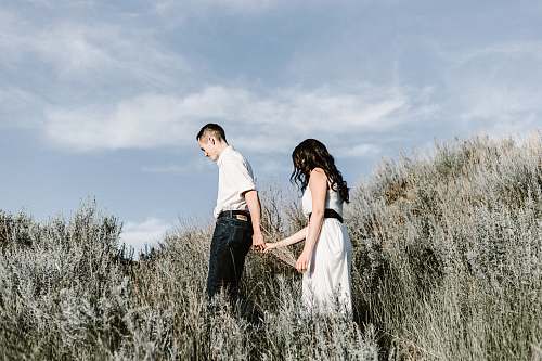 people couple walks of grassy field human