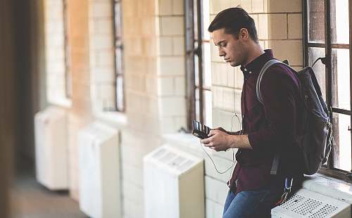 people man leaning while holding leather wallet human