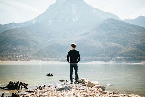 people man standing on front of lake at daytime lake