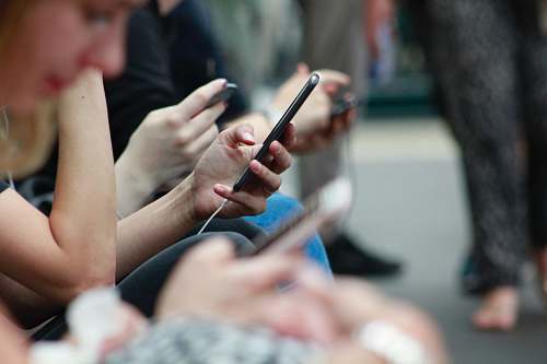 people person holding black phone human