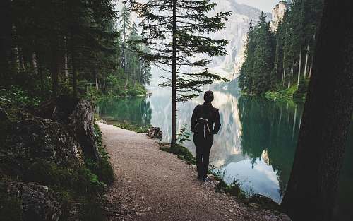 people person stands near lake nature