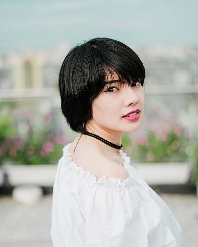 people selective focus photo of woman wearing white top and black choker necklace woman
