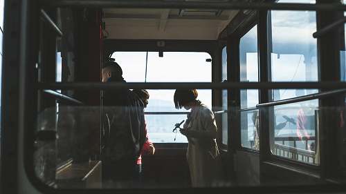 people woman and man inside cable car window