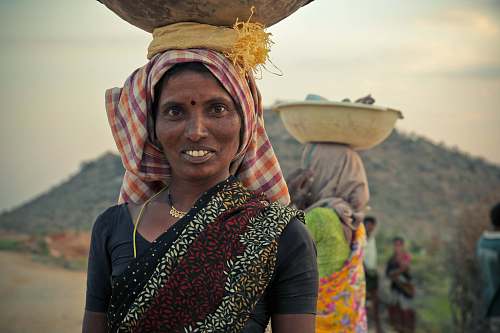 people woman in black top with brown bowl on head india