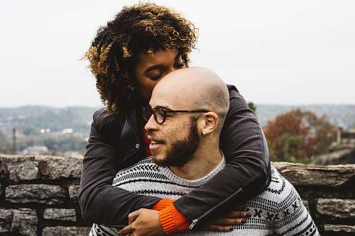 people woman kissing man's head couple