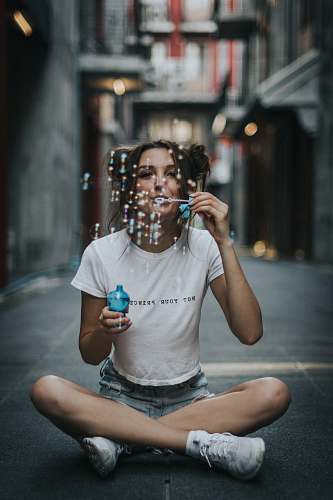 people woman sitting blowing bubbles human