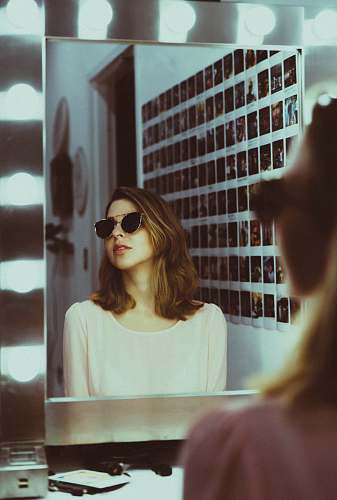 people woman sitting in front of vanity mirror human