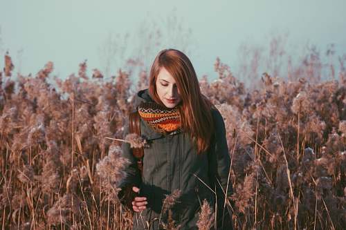 people woman standing near grey flowers human