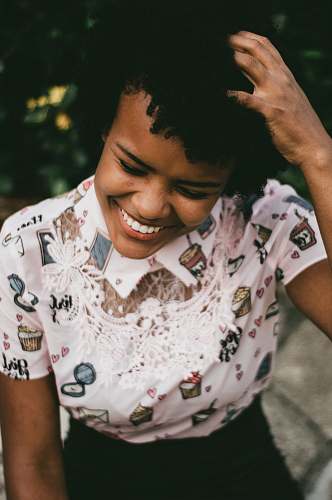 people woman touching her hair while smiling human