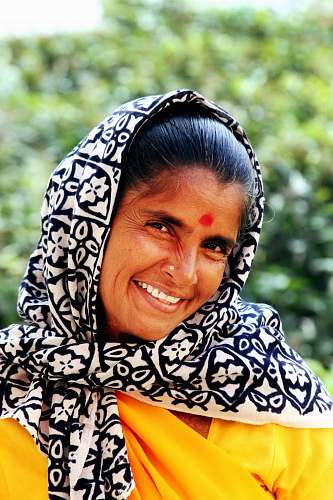 woman woman wearing white and black floral scarf while smiling india