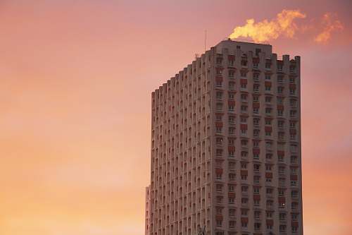  gray building under orange sky 