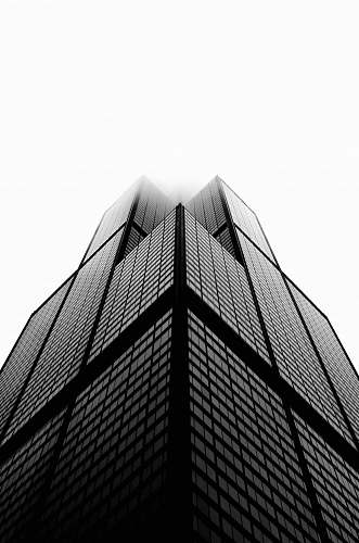 black-and-white aerial photo of building under white sky skyscraper