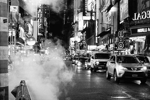 car grayscale photo of cars on road automobile