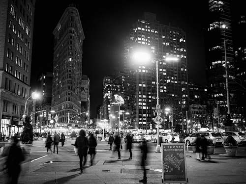 human grayscale photo of people on street and buildings pedestrian