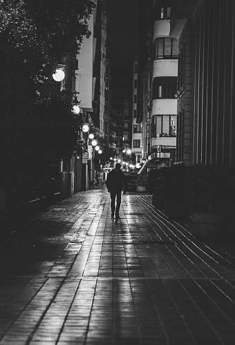 human grayscale photography of person walking person