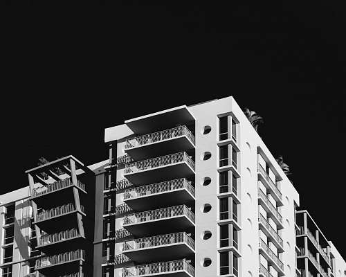 building white tall building grey-scale photography city