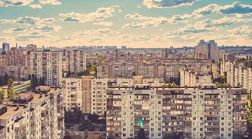 city aerial photo of city buildings under cloudy sky during daytime urban