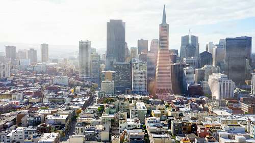 city aerial photography of concrete buildings under blue cloudy sky san francisco