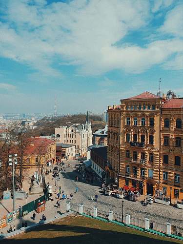 town aerial photography of people standing near road during daytime urban