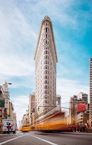 city beige concrete building near cars architecture