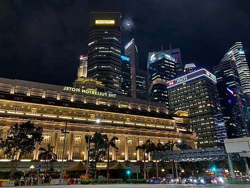 city beige high-rise building during night time downtown
