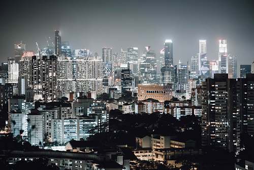 city black and white high buildings at nighttime town