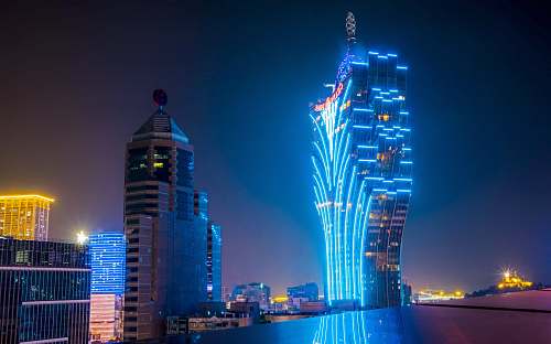 city blue and black lit high-rise building metropolis