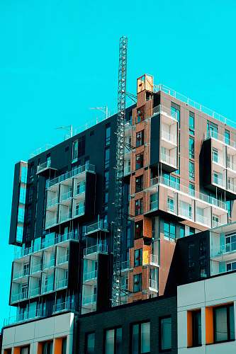 city brown and black concrete building during daytime high rise