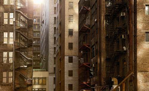 city brown buildings under sunny sky windows