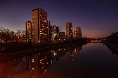 city brown concrete building beside water urban