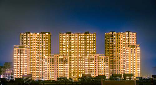 city brown concrete buildings at night high rise