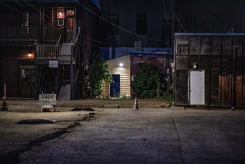 urban brown house beside paved road road