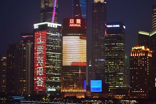 city building lot during nighttime with lights office building