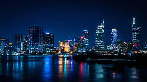 city buildings near body of water during nighttime town