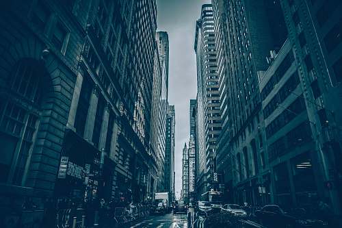 city cars of road between buildings on vignette photography urban