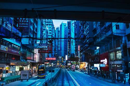 city cars passing by commercial buildings urban