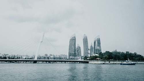 city city buildings under cloudy sky high rise