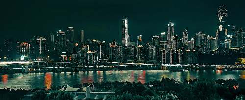 city concrete buildings beside body of water town