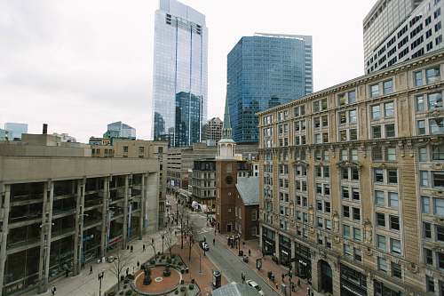 city crowd walking between buildings downtown