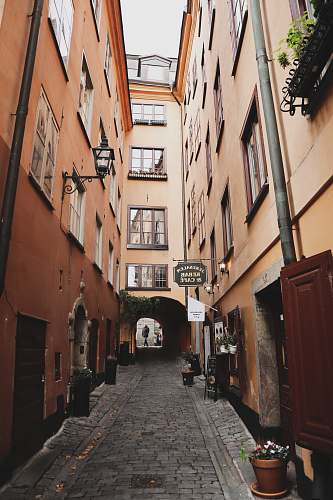 city empty alley between apartment buildings road