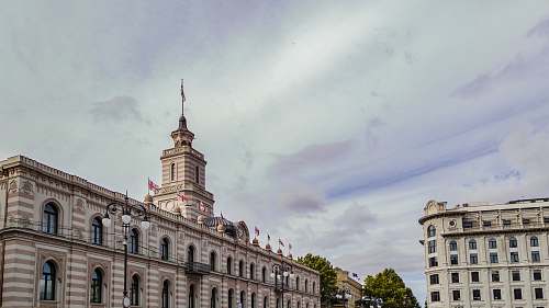 city European-styled concrete buildings under cloudy sky urban