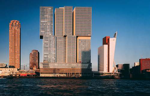 city gray concrete building near body of water high rise