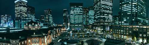 city gray high rise buildings at night town