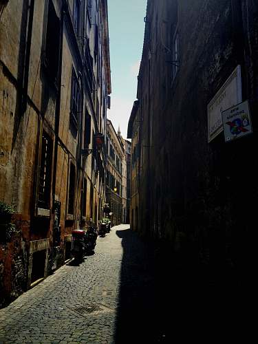 alley gray pathway between buildings alleyway
