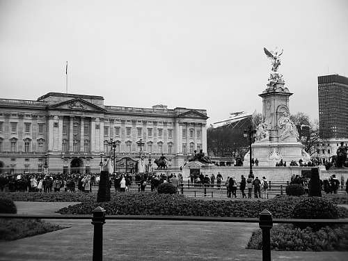 city grayscale photo of people near building black-and-white